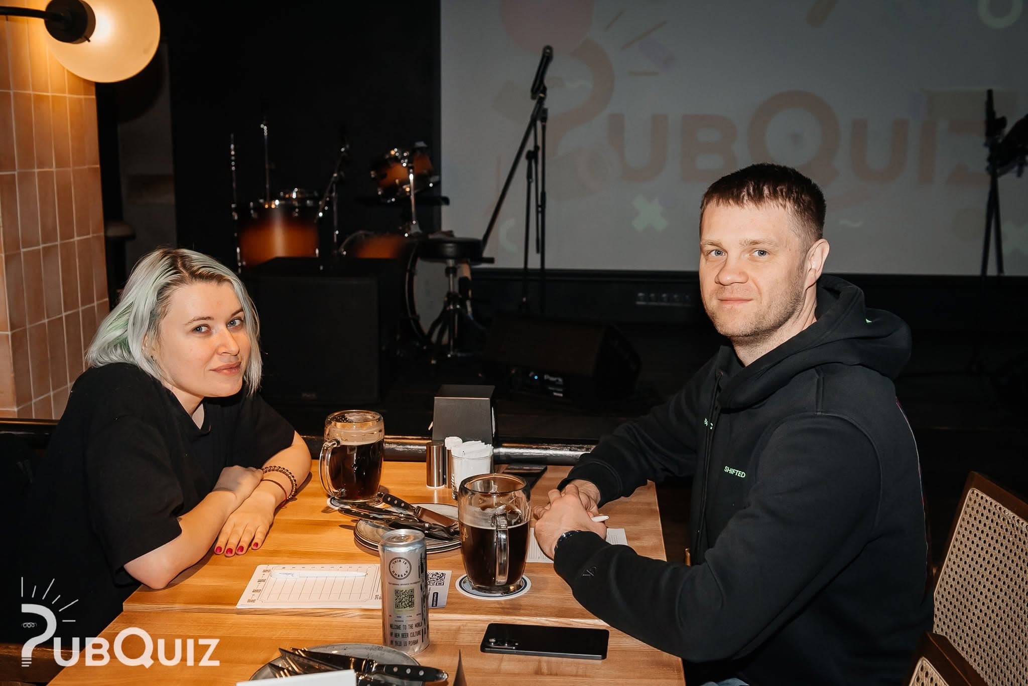 Пара гравців на фоні сцени PubQuiz